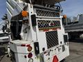 A 2015 Global Street Sweeper featuring a rear view with visible lights and a metal mesh grille for debris collection
