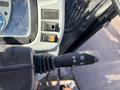 Close-up of a tractor control lever with various settings and a switch for lights on a 2010 New Holland T4050