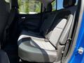 The interior seating of a 2021 Chevrolet Colorado showing the back seat with gray and black upholstery and a spacious layout