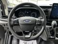 Steering wheel and dashboard of a 2022 Ford Transit with digital display and gear shift lever visible