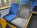 Two bus seats in a 2018 Grande West Vicinity one is blue with a cross pattern and the other is gray with a mesh texture