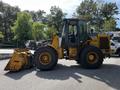 A 2010 John Deere 444K wheeled loader with a large bucket in front and a cabin on the right side