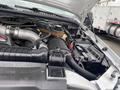 Engine compartment of a 2003 Ford F-450 SD showcasing various components including the air intake and battery cables