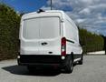 A white 2015 Ford Transit van viewed from the rear showcasing its large cargo space and distinctive rear lights