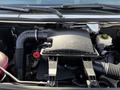 Engine compartment of a 2016 Mercedes-Benz Sprinter featuring the air intake and various components including hoses and a reservoir