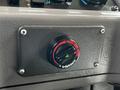 A black control knob with a red ring labeled Webasto located on a gray dashboard, indicating temperature settings or ventilation adjustments