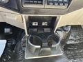Interior console of a 2008 Ford F-450 SD featuring a cup holder and control buttons