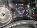Dashboard display of a 2022 Dodge Charger showing fuel economy range average and speedometer with gauges for RPM and temperature