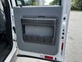 Door panel of a 2016 Ford F-550 with a grey interior finish featuring a storage compartment and handle