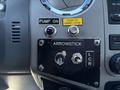 Dashboard controls of a 2016 Ford F-550 featuring buttons labeled Pump On Push to Start Stop and Arrowstick with two switches LCR and another switch
