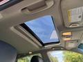 Interior view of a 2017 Infiniti QX50 showing a sunroof with clear sky visible above and overhead controls on the ceiling