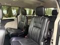 Interior view of a 2017 Dodge Grand Caravan showcasing black leather seats arranged in two rows with seating capacity for up to seven passengers