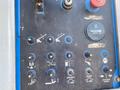 A control panel featuring various switches and icons for operating a Genie S-65 4X4 including indicators for engine and function enablement