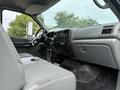 Interior of a 2004 Ford F-750 featuring gray upholstery and dashboard with controls and gauges visible on the passenger side