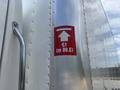 A metallic panel on a 2015 Freightliner M2 106 truck displaying a red arrow sign indicating a height of 13 feet