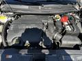 The engine compartment of a 2013 Lincoln MKT featuring the engine block with various components including the battery and hoses