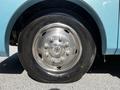 Close-up of a tire and wheel from a 2000 Ford Motorhome featuring a shiny silver rim with multiple bolts and a black tire with visible tread pattern