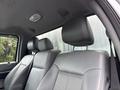 Interior of a 2015 Ford F-350 SD displaying two front seats with gray leather upholstery and headrests