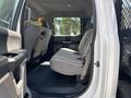 Interior view of a 2017 Ford F-550 showing the back seat with fabric upholstery and seat covers on either side