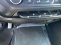 Interior dashboard controls of a 2014 GMC Sierra 1500 featuring climate control buttons and a texturized panel