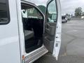A 2016 Chevrolet Express van with the driver's side door open revealing the interior and dashboard