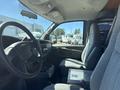 Interior view of a 2007 Chevrolet Express showing the front seats and dashboard with gray fabric upholstery and a center console