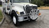 A white 2006 International 7500 truck with a prominent front grille and a large aluminum bumper attachment