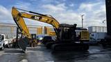 A 2018 Caterpillar 326F L Excavator with a yellow arm and black body is shown in a parking area ready for operation