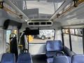 Interior view of a 2018 Chevrolet Express showing seats and overhead features including lights and handrails