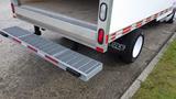 A 2018 Ford Transit with a lowered loading ramp extended from the rear of the vehicle