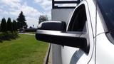 A white 2014 RAM 5500 truck with a prominent side mirror visible in the foreground