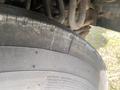 Close-up of a tire from a 1987 Chevrolet Fleetwood Pace Arrow showing tread patterns and side markings