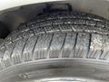 A close-up view of a Michelin tire with visible tread patterns on a 2012 Chevrolet Express