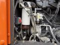 Close-up of the engine compartment of a 2018 Doosan DL300-5 showing fuel and hydraulic lines alongside a filter and various components