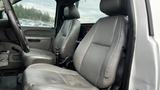 Interior of a 2013 Chevrolet Silverado 1500 showing two gray leather front seats with visible wear and tear