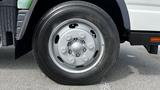 Close-up of a silver wheel of a 2018 Mitsubishi Fuso FE truck showing the tire tread and wheel rim details