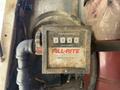 Close-up of a Fill-Rite series 900 meter displaying zeros on the meter screen with a black knob and a pipe connection visible