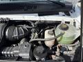 Close-up view of the engine compartment of a 2019 Ford Econoline showing various components including the air intake the coolant reservoir and the battery