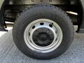 A close-up view of a Goodyear tire mounted on a silver wheel from a 2022 Ford Transit with visible tread patterns and a sturdy design