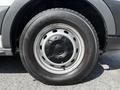 Close-up of the wheel and tire of a 2015 Ford Transit showing a silver steel rim and a black tire with visible tread pattern