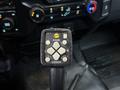 A control panel with buttons labeled for raising and lowering features on a 2023 Ford F-250 including options for scoop and track