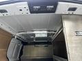 Interior view of a 2014 Ford Transit Connect showcasing the ceiling and storage area with metal framework and reflective surfaces
