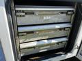 Three metal drawers inside a compartment of a 2004 Freightliner M2 truck with handles and visible wear