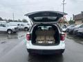 A 2016 Ford Explorer with the rear hatch open showing the folded down third-row seats in the cargo area