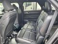Interior view of a 2021 Ford Explorer showing two black leather rear seats and seatbelts