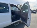 A 2015 Ford F-450 Super Duty truck with its driver's side door open revealing the interior and seats
