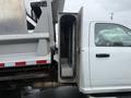 A 2011 Dodge Ram 5500 with an open side compartment revealing a metal interior and a flat loading area