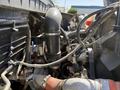 Close-up of the engine compartment of a 2009 International 7500 featuring visible hoses and components including an air intake and wiring