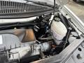 The engine compartment of a 2022 GMC Savana showcasing the engine components including the oil filter reservoir and coolant tank