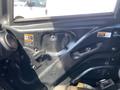 Interior door panel of a 2018 Kubota RTV-X 1100 C featuring controls and warning labels